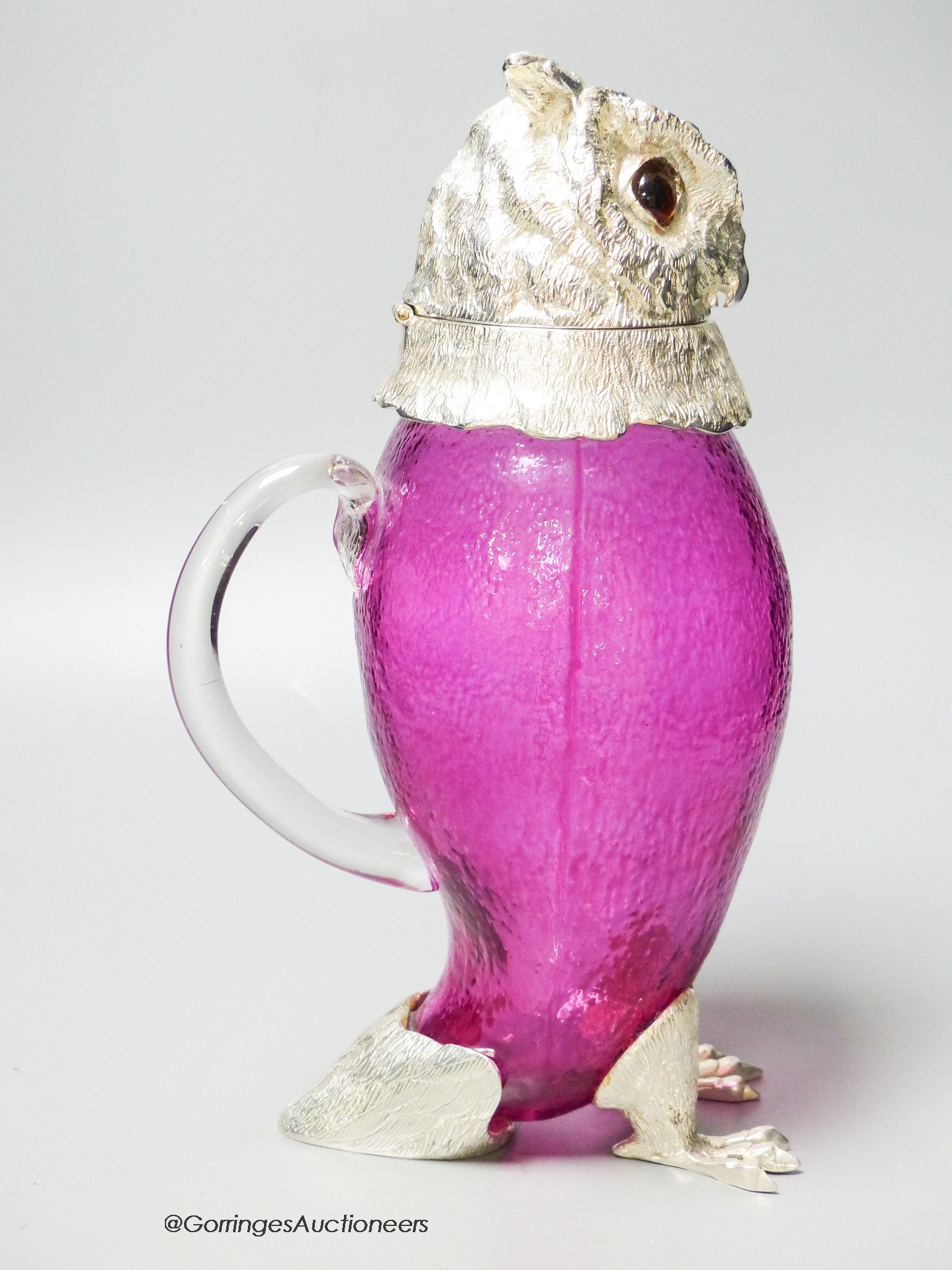 A cranberry glass and electroplate 'owl' claret jug, height 29cm